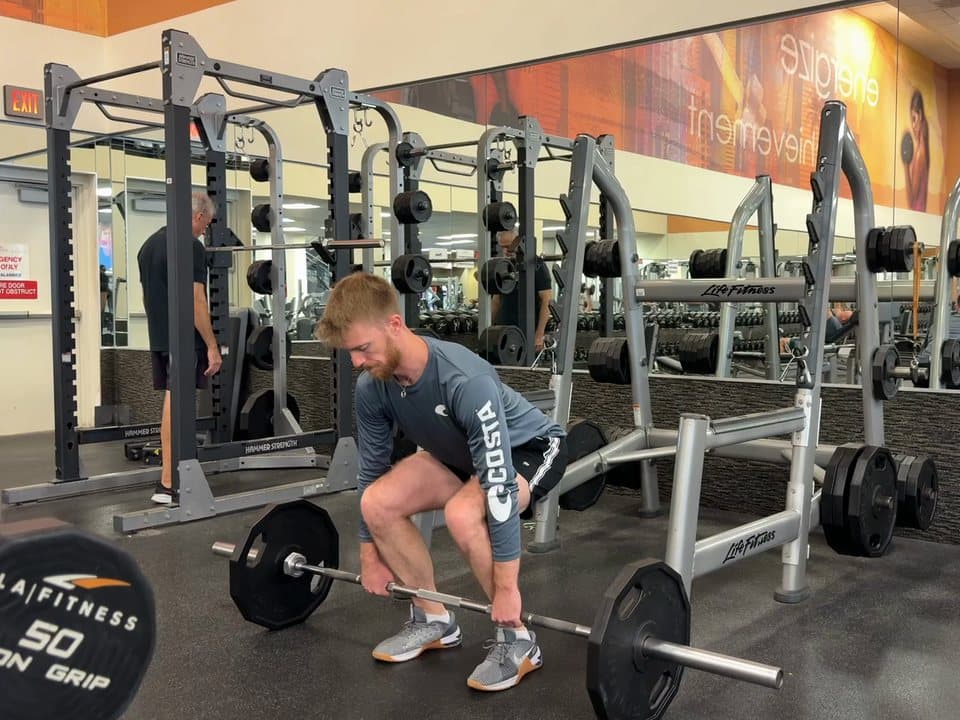 Connor Barth doing a power clean: the bar from the floor to his shoulders, and back down.